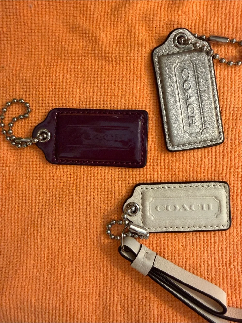 Coach Trio of Leather and Patent Tag Charms with Cream Wristlet